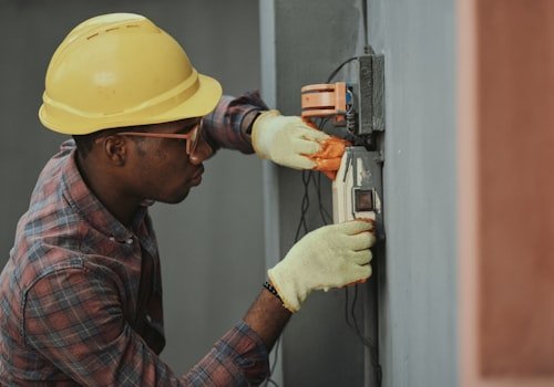 A tradesperson wiring an electrical fitting on site